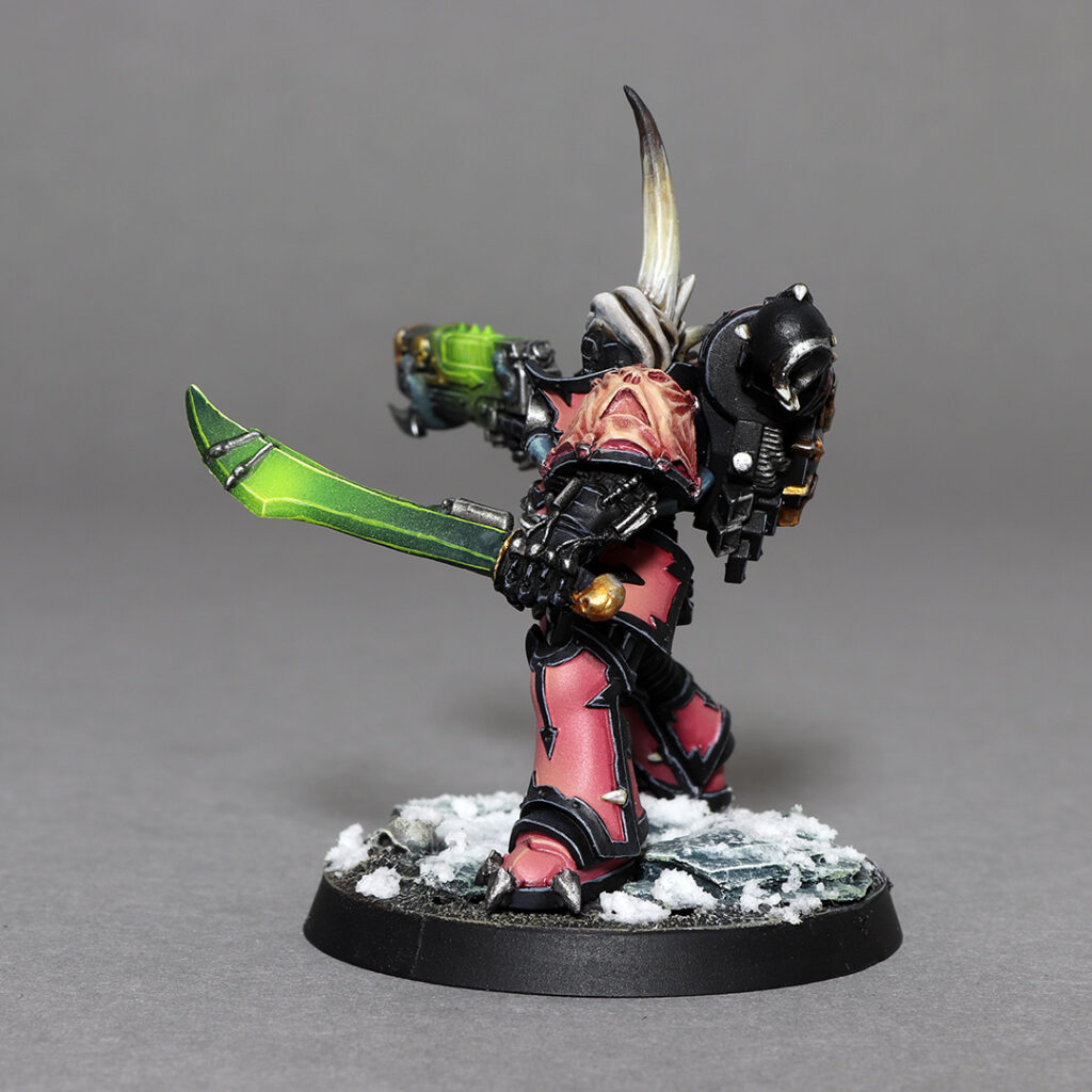 Chaos Space Marines Emperor's Children Aspiring Champion, armed with Power Sword and Plazma Gun, painted by Castle Brush Miniature Painting Studio, conversion using Games Workshop kit & parts; left back side of the miniature
